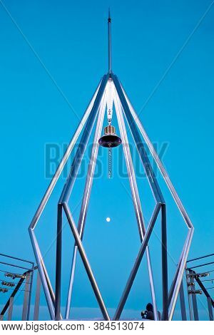 The Bell At Top Of Mt. Moiwa In Sapporo City, Hokkaido, Japan With Night Cityscape Blur Background.