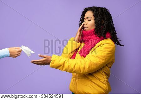African American Girl Suffering From Nose Bleeding Taking Tissue To Stop Blood Standing On Purple St