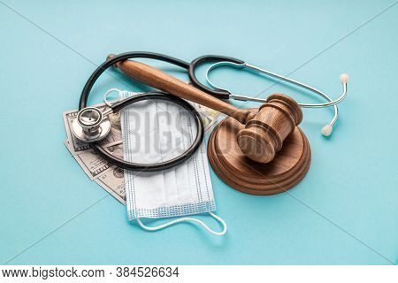 Wooden Judge Gavel With Medical Mask Stethoscope And Money On Blue Background Healthcare Legislation