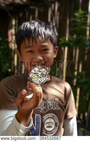 Philippines, Palawan, Coron Island, December, 2019 -  Filipino Young Boy With A Butterfly On His Han