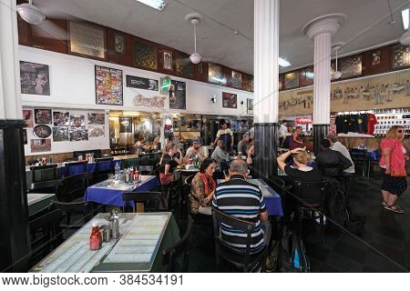 MUMBAI, INDIA - FEBRUARY 14, 2020: Customers at popular old style restaurant The Leopold Cafe Colaba in Mumbai, India