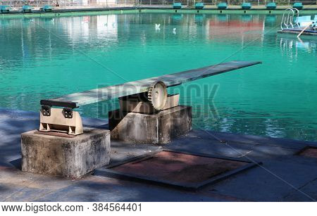 Springboard At The Swimming Pool. It Is A Strong, Flexible Board From Which Someone Can Jump In Orde