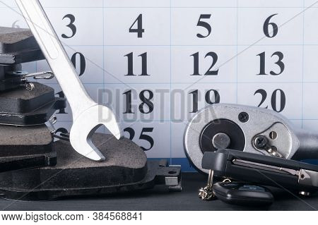 Background Of A Set Of Spare Parts Items And A Calendar, Brake Pads And Spanners