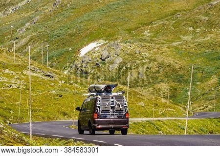 Sognefjellet, Norway - July 7, 2018: Camper Van With With Recreational Equipment Conoes On Roof Driv