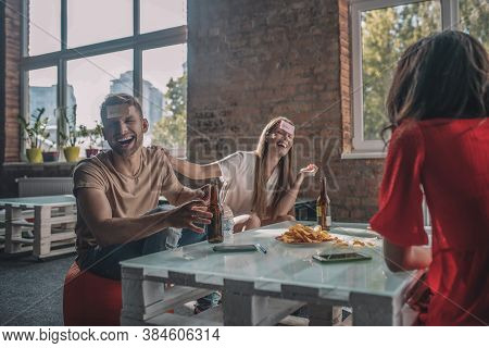 Friends Having Fun While Playing A Decktop Game