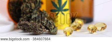 On Table Marijuana In Jar And Hemp Oil In Capsules. Help For Cancer Patients. Medical Cannabis Reduc