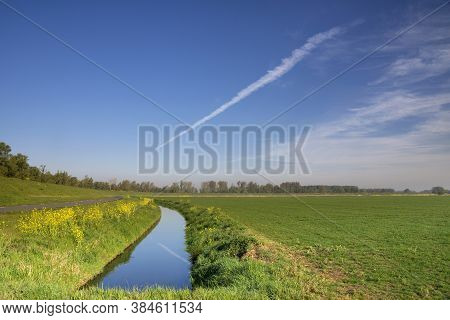 Ditch In A Green Grassy Meadow Near Hank In The Dutch National Park De Biesbosch