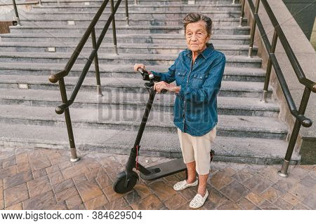 Old Woman Near Scooter. Grandmother Progressive Woman. Senior Having Fun. Old Woman Enjoying Her Hob
