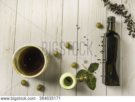 Bottle Oil And Olives Like Ingredients On Table