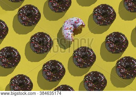 One White Chocolate Donut Lay Down Between Black