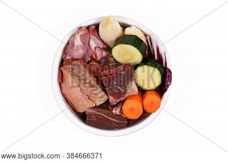Dog Bowl With Species Appropriated Raw Food Like Chunks Of Raw Meat, Fish, Chicken Stomache And Vege