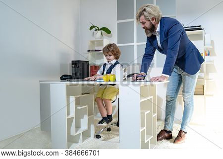 Little Boss. Group Of Four Business Colleagues In Suits Working On Project. Little Businessman Bossy
