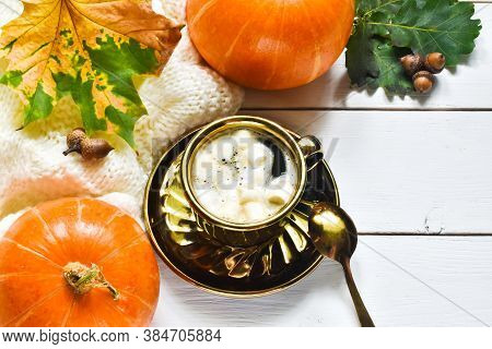 Autumn Composition With Cup Of Pumpkin Latte With Marshmallow,  Leaves And Pumpkin On White Wooden B