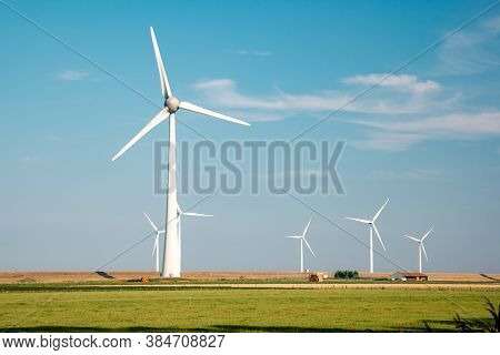 Offshore Windmill Park With Stormy Clouds And A Blue Sky, Windmill Park In The Ocean