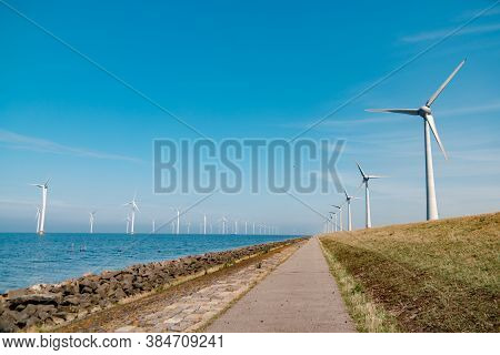 Offshore Windmill Park With Stormy Clouds And A Blue Sky, Windmill Park In The Ocean