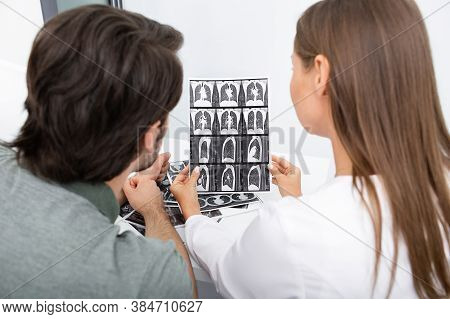 Pulmonologist Showing A Man Patient A Ct Scan Of His Lungs During A Consultation. Pneumonia, Coronav
