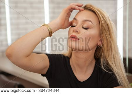 Attractive Blond Haired Woman Touching Her Hair Sensually