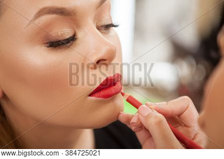 Close Up Of A Woman Having Her Lips Painted With Red Lipstick By Professional Makeup Artist