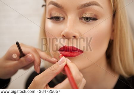 Close Up Of A Beautiful Woman Getting Professional Makeup By Beautician At The Salon