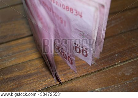 Indonesian Rupiah Money Called Idr On The Wooden Table