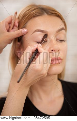 Vertical Close Up Of A Gorgeous Woman Having Her Makeup Done By Professional Makeup Artist