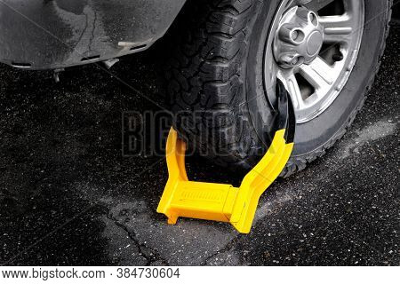 Wheet boot or tire lock on a vehicle or car for illegal parking violation 