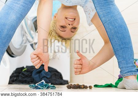 Woman Comparing Washing Laundry Nuts And Chemicals Detergent Blue Pods. Alternative Household Duties