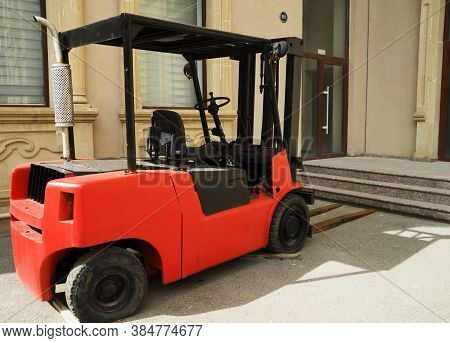 Red Rough Terrain Forklift In The Yard.