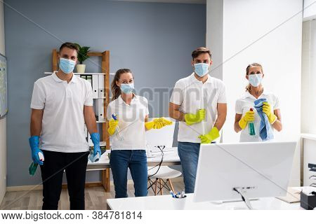 Professional Office Cleaning Janitor Team In Uniform And Face Masks