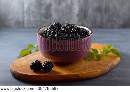 Close-up Of Fresh Blackberries In Bowl On Rustic Board On Table