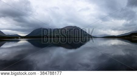 Panoramic View Of Nares Lake With Mountains In The Background During A Cloudy Evening. Taken In Carc
