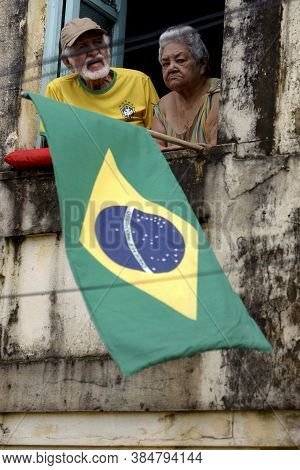 Salvador, Bahia / Brazil - July 2, 2015: Person Holds Brazilian Flag In The Lapinha Neighborhood Of 