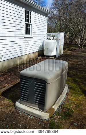 A Residential Standby Generator And Propane Tank