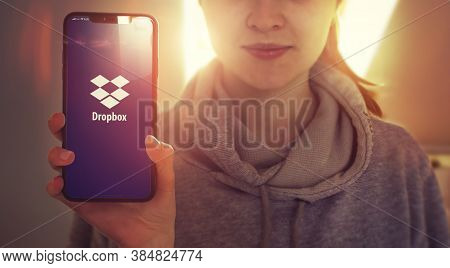 Kyiv, Ukraine-january, 2020: Dropbox On Smart Phone Screen. Young Girl Showing Cellphone Screen With