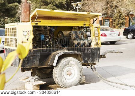 Yellow Electric Generator Worked On City Street.