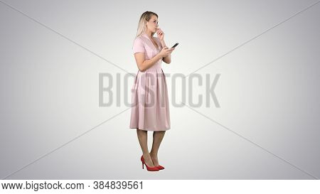 Blonde Teenager Woman Wearing Pink Texting Message On Her Smartp