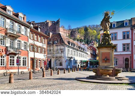 Heidelberg, Germany - April 2020: Square Called 'kornmarkt' In Old Historical City Center, Fountain 