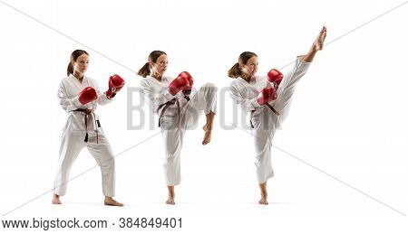 High. Junior In Kimono Practicing Taekwondo Combat, Martial Arts. Young Female Fighter With Red Glov