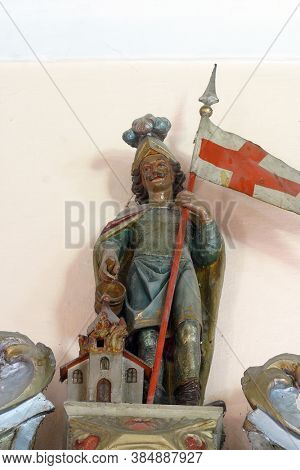 PETROVINA, CROATIA - JULY 22, 2013: Saint Florian statue on the altar of Saint Michael in the parish church of Saint Peter in Petrovina, Croatia
