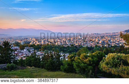 View Of Athens And Its Residential Areas From Pnyx Hilltop In Soft Evening Sunlight With Great Sunse
