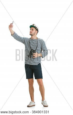 Taking Selfie. Caucasian Male Sailor In Uniform On White Studio Background. Young Man Using Modern D