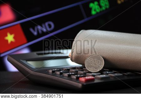 Two Hundred Vietnam Dong Coin On Reverse (vnd) On Black Calculator And Wallet With Digital Board Of 