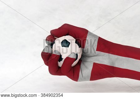 Mini Ball Of Football In Denmark Flag Painted Hand On White Background. Concept Of Sport Or The Game