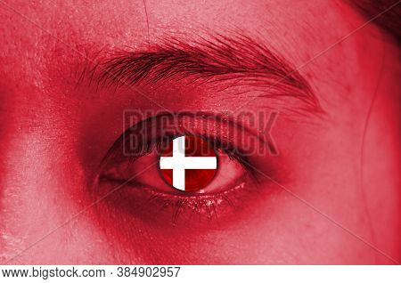 Abstack Red Human Face And The Eye With National Flag Of Denmark. Human Eye Painted With Flag Of Dan