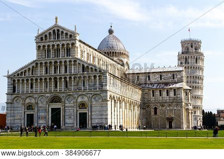 Pisa, Italy - March 17, 2012: People Walking Near The Pisa Baptistery Of St. John And The Leaning To