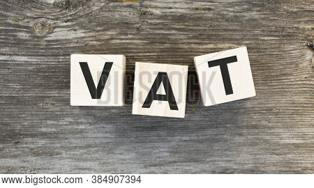 Vat On Wooden Cubes Over Blur Background With Copy Spcae, Financial Concept Background