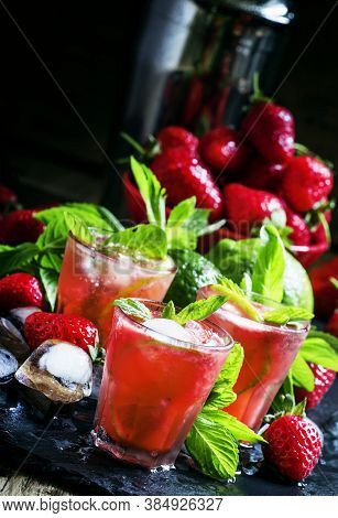 Alcoholic Cocktail Strawberry Mojito With White Rum, Syrup, Soda, Lime, Mint And Ice, Black Backgrou