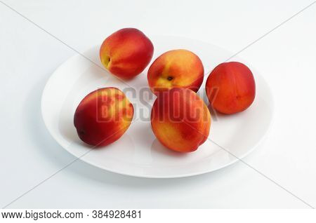 Fresh Nectarines On A Plate. White Background. Group