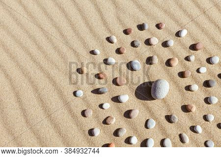 Pattern Of Colored Pebbles In The Shape Of A Circle On Clean Sand. The Concept Of Serenity And Medit