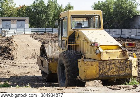 Bulldozer At A Construction Site. Heavy Construction Equipment. Sand Compactor. Multi-ton Diesel Car
